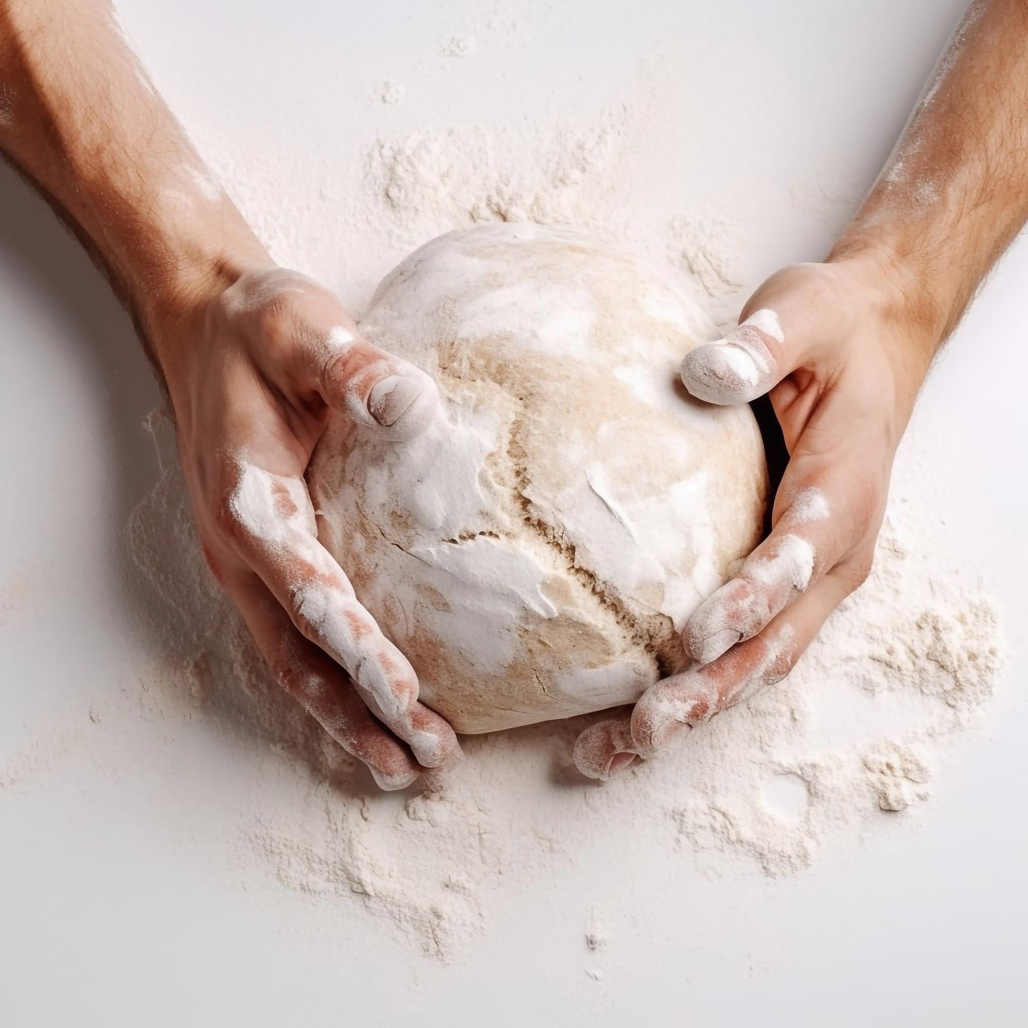 Instructor shaping dough in studio kitchen